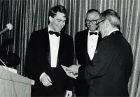 A 1985 photo shows Peter Bolo receiving the gold medal given to a graduating student in recognition of interest in and devotion to the school and its alumni association. His son, Kyle Bolo’19, received the same award in May 2019.
